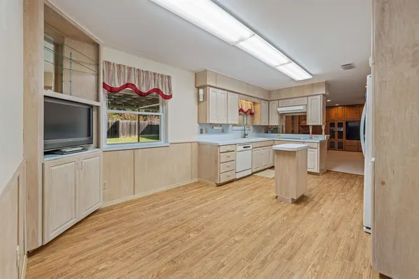 a kitchen with stainless steel appliances kitchen island granite countertop a stove top oven and sink