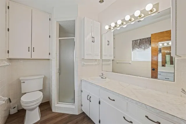 a bathroom with a sink a toilet and a large mirror