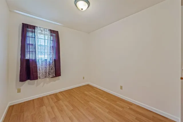 a view of a room with wooden floor and windows