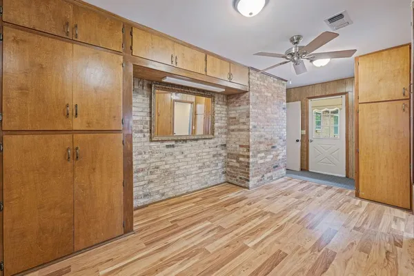 a view of a hallway with wooden floor and entryway