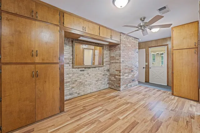 a view of a hallway with wooden floor and entryway