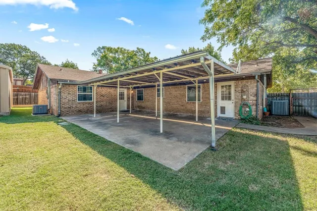 a view of a house with a yard and sitting area