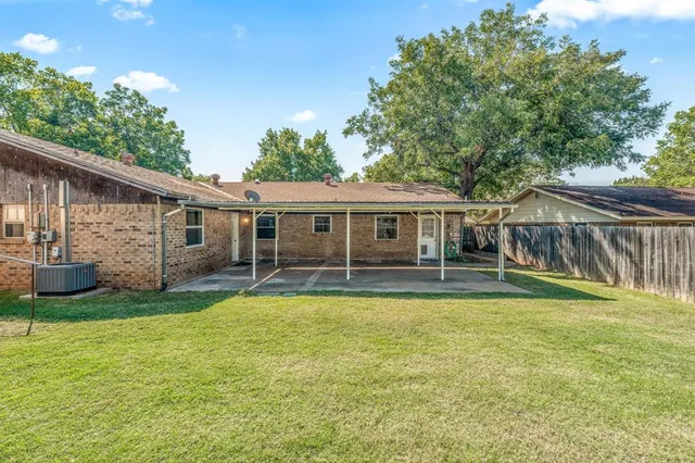 a view of a house with a yard and sitting area