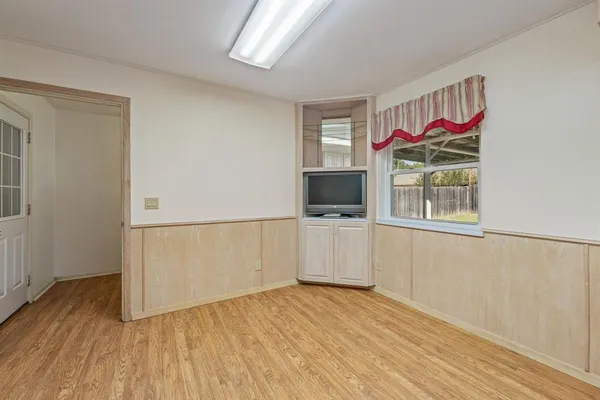 a view of a kitchen with microwave and cabinets