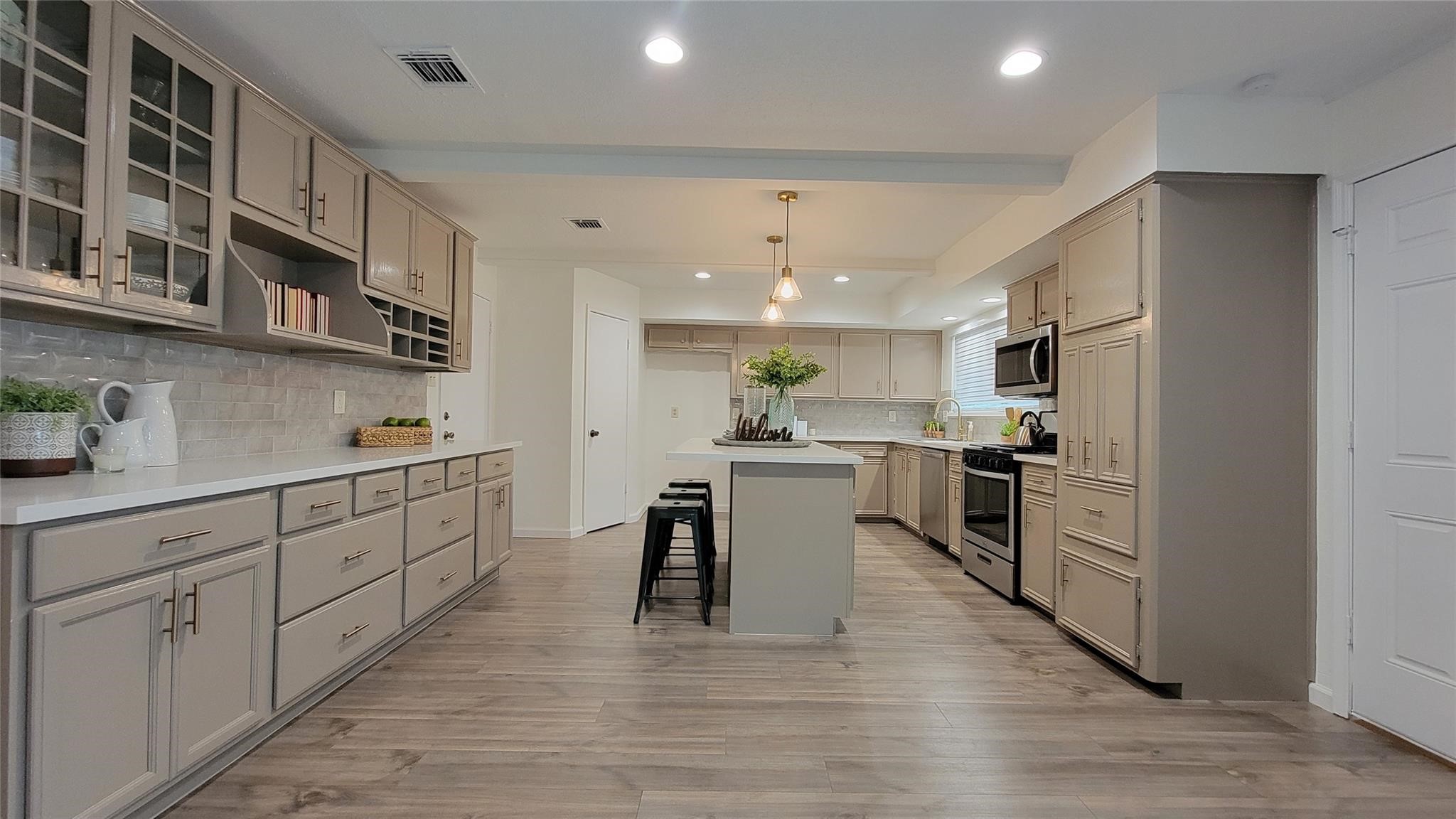 3210 Haydee Road Spring, TX 77388 - Photo 2 of 12 a kitchen with white cabinets and stainless steel appliances