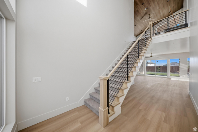 3011 East Rimrunner Drive, Unit 302 St. George, UT 84790 - Photo 8 of 45 Staircase featuring wood finished floors, ceiling fan, and a high wood ceiling