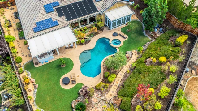a kitchen with kitchen island granite countertop a sink and refrigerator