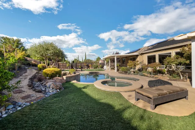 a kitchen with stainless steel appliances granite countertop a sink and stove