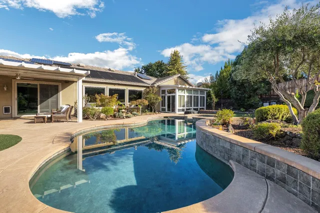a kitchen with kitchen island granite countertop a stove and a sink