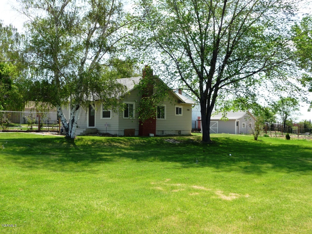 6908 Mieras Road Yakima, WA 98901 - Photo 1 of 4 a view of a house with a backyard