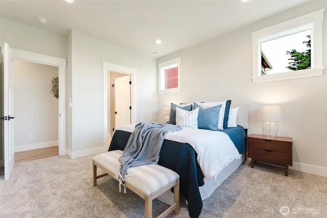 a spacious bedroom with a bed and a painting