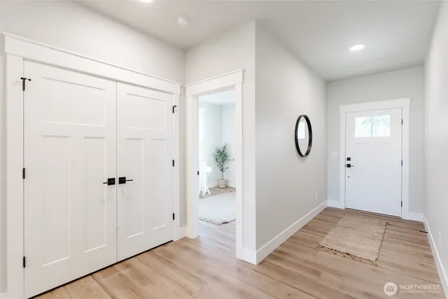a view of a room with wooden floor and white doors