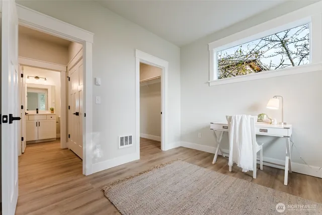 a view of an empty room and wooden floor