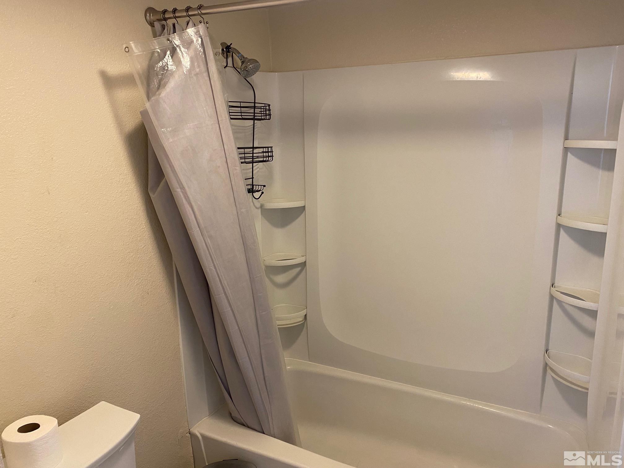83 Vista Rafael Parkway, Unit 83 Reno, NV 89503 - Photo 13 of 16 a bathroom with a tub and a shower
