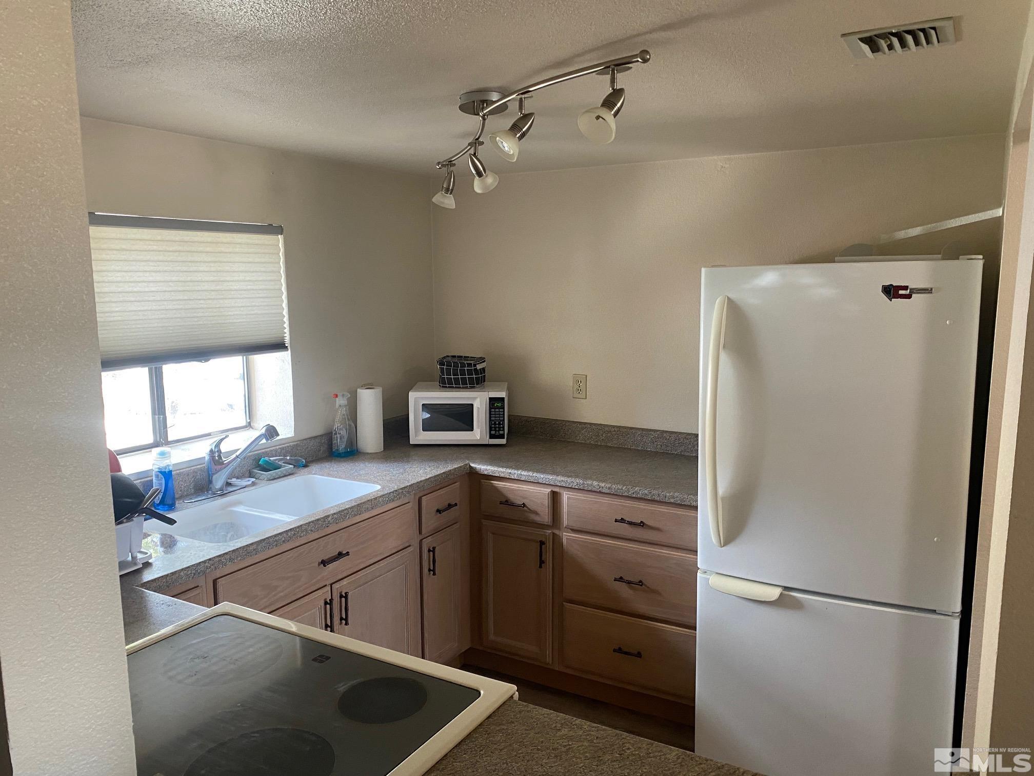 83 Vista Rafael Parkway, Unit 83 Reno, NV 89503 - Photo 6 of 16 a kitchen with a sink cabinets and refrigerator