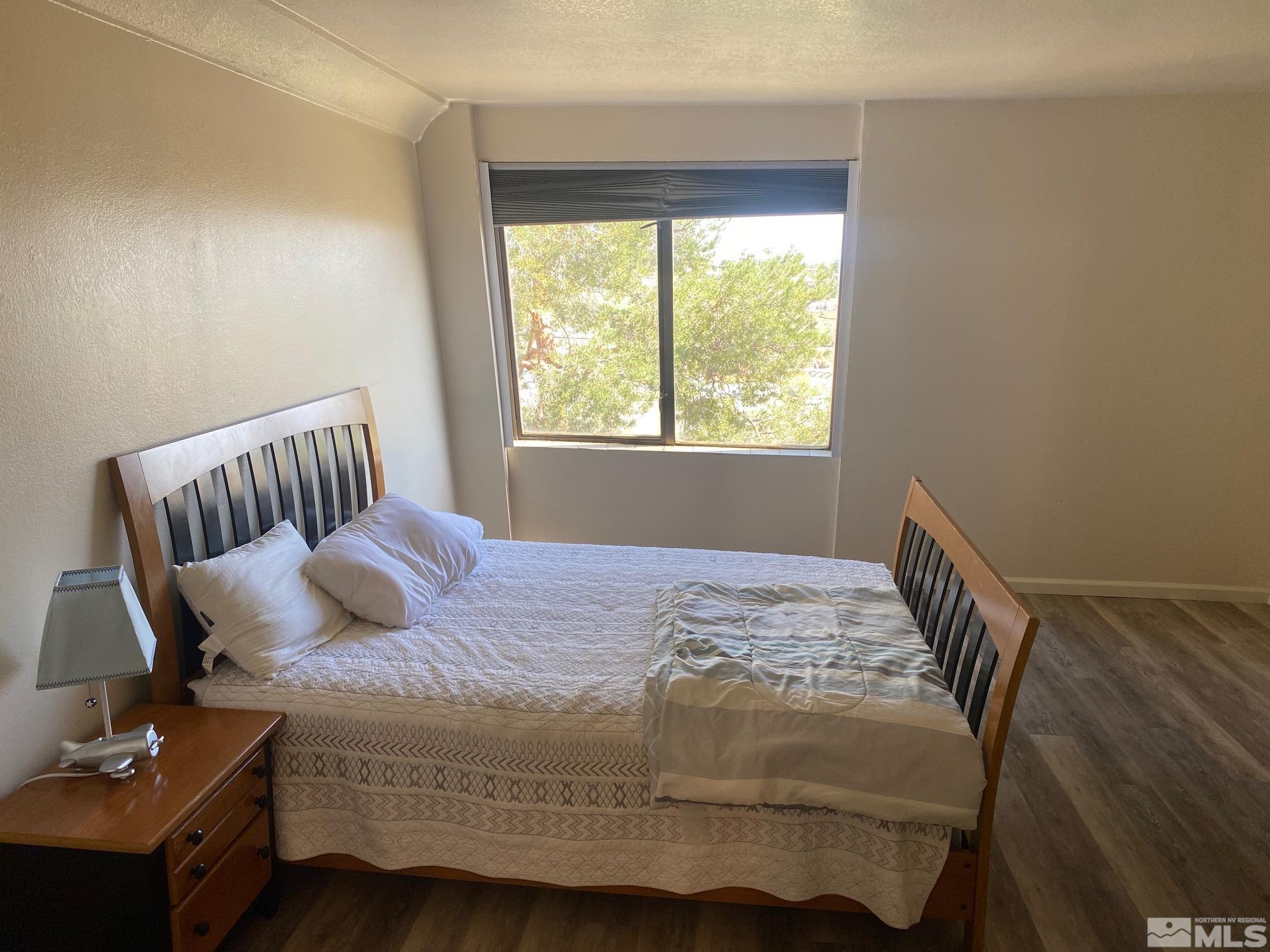 83 Vista Rafael Parkway, Unit 83 Reno, NV 89503 - Photo 7 of 16 a bedroom with a bed and wooden floor