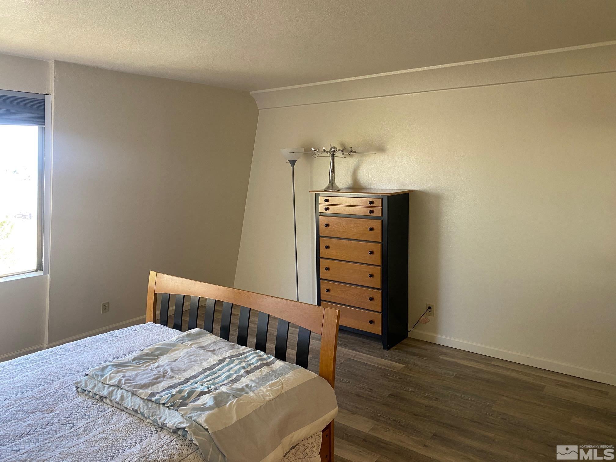 83 Vista Rafael Parkway, Unit 83 Reno, NV 89503 - Photo 8 of 16 a bedroom with a bed and wooden floor