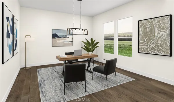 a view of a livingroom with furniture window and wooden floor