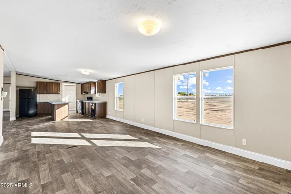 a view of an empty room with a window and a ceiling fan