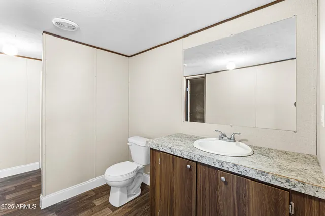 a kitchen with granite countertop a sink a stove and cabinets