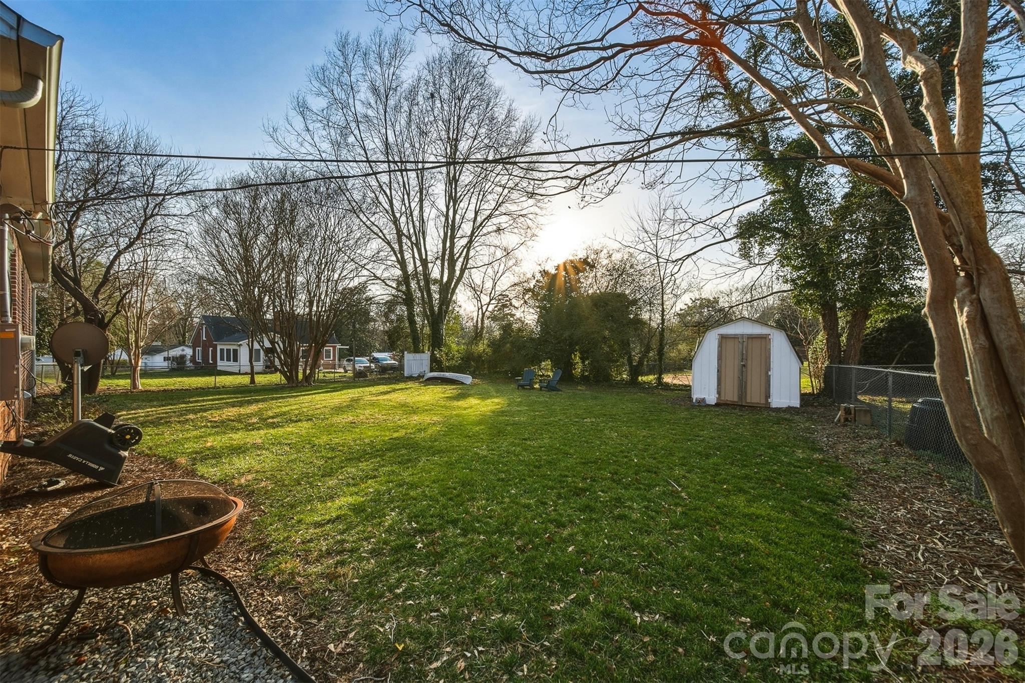 1519 3rd Street Northwest Hickory, NC 28601 - Photo 11 of 48 a view of a backyard with fountain plants and large tree