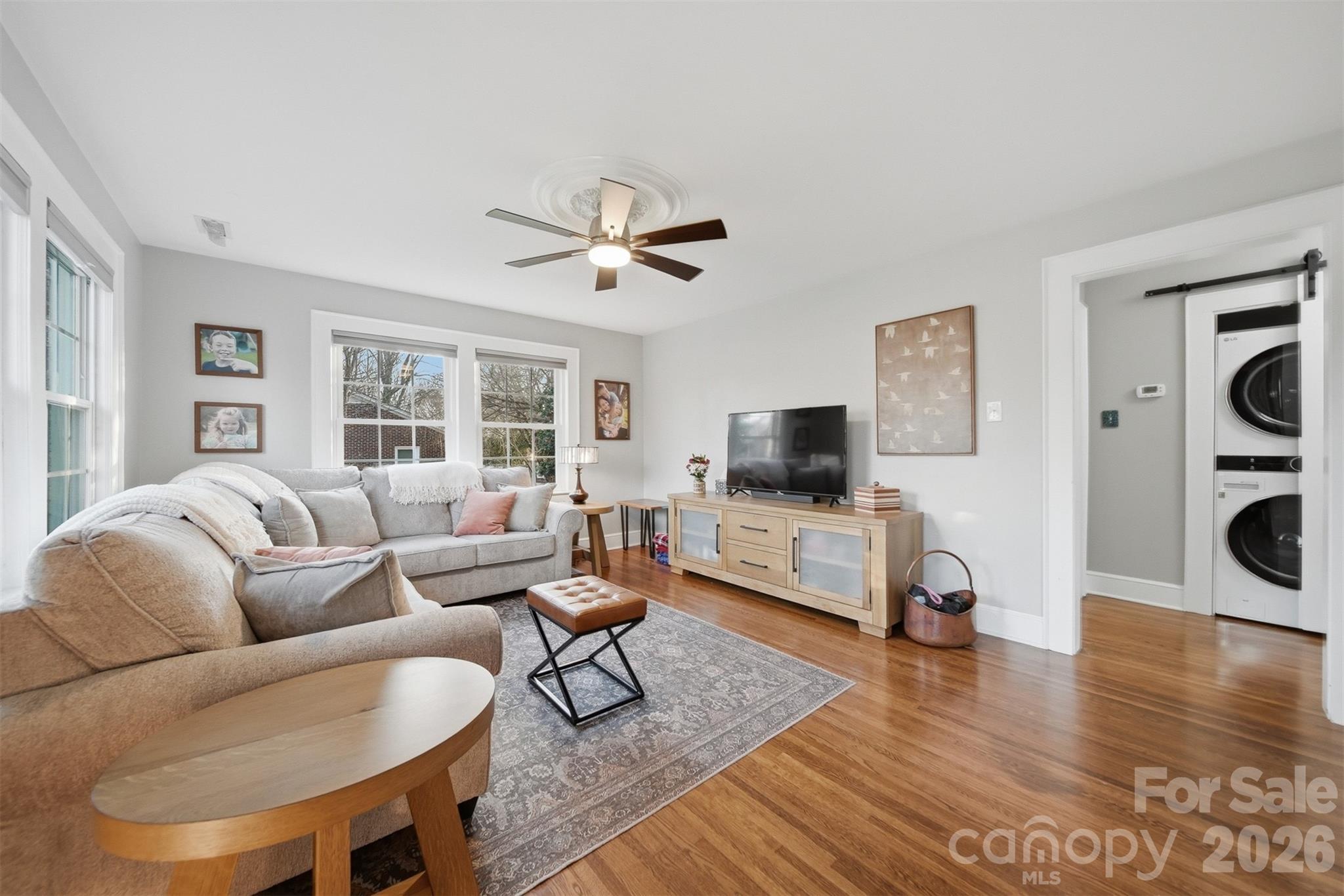 1519 3rd Street Northwest Hickory, NC 28601 - Photo 17 of 48 a living room with furniture a flat screen tv and a large window