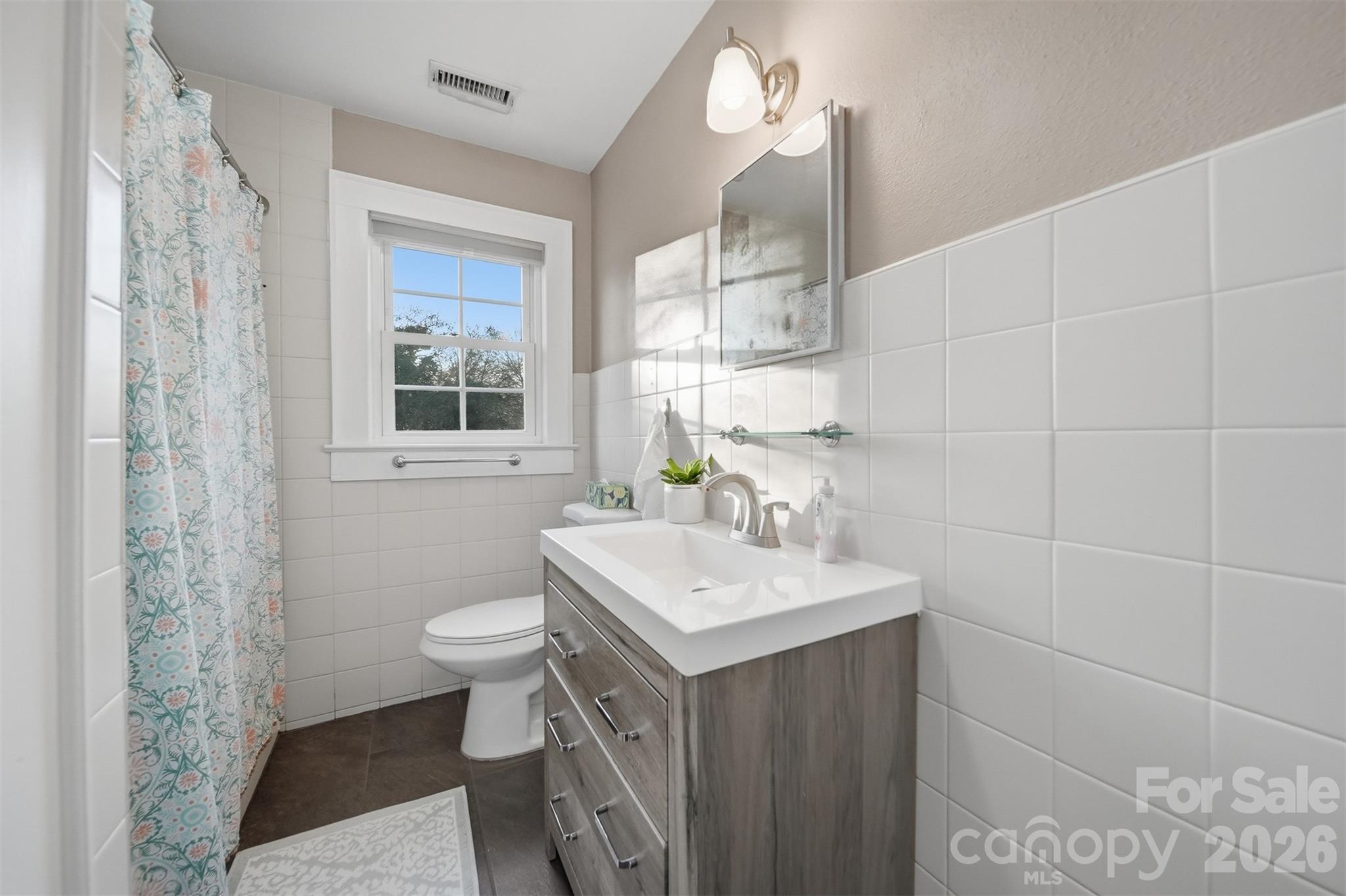 1519 3rd Street Northwest Hickory, NC 28601 - Photo 18 of 48 a bathroom with a sink toilet and mirror
