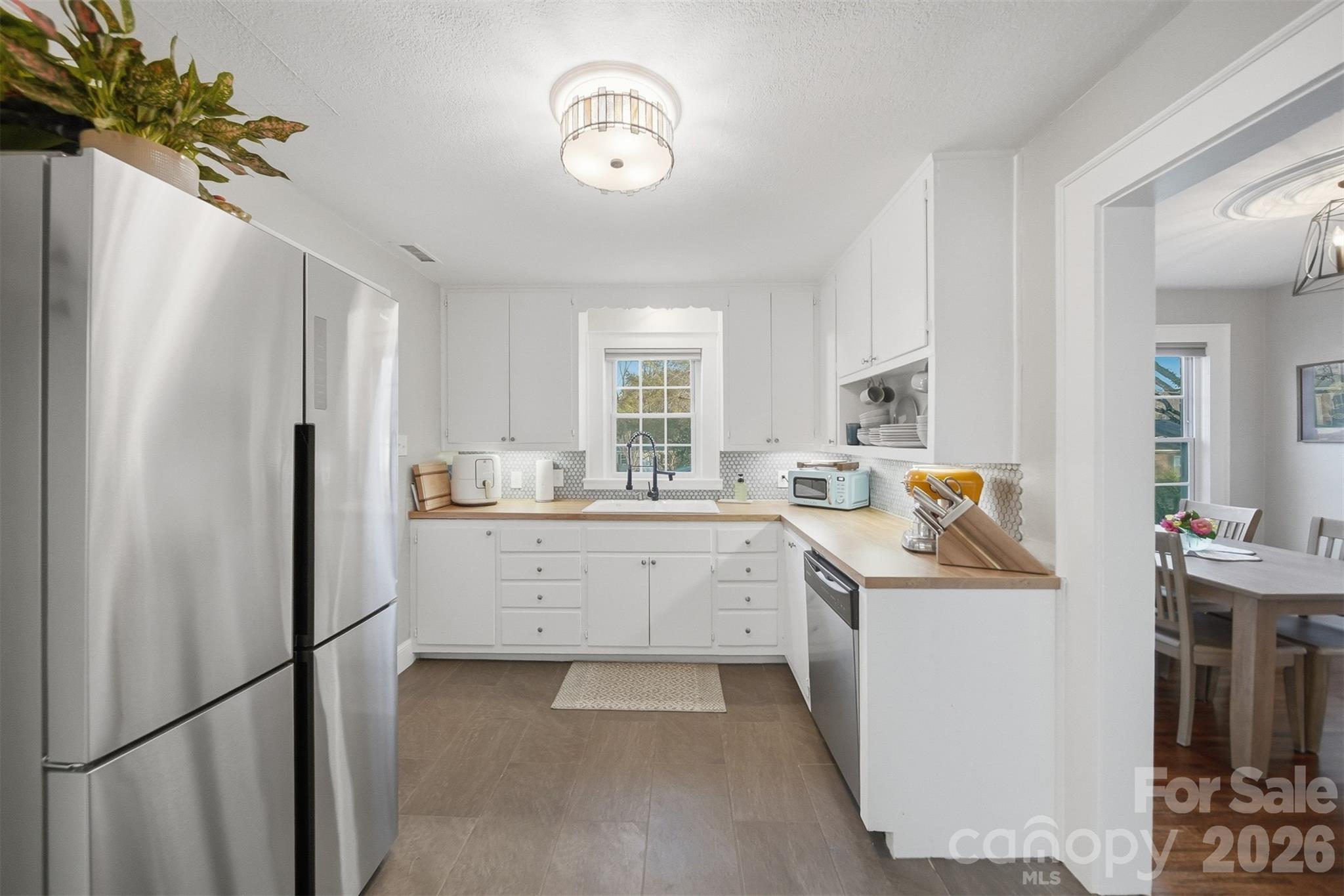 1519 3rd Street Northwest Hickory, NC 28601 - Photo 23 of 48 a kitchen with white cabinets and refrigerator