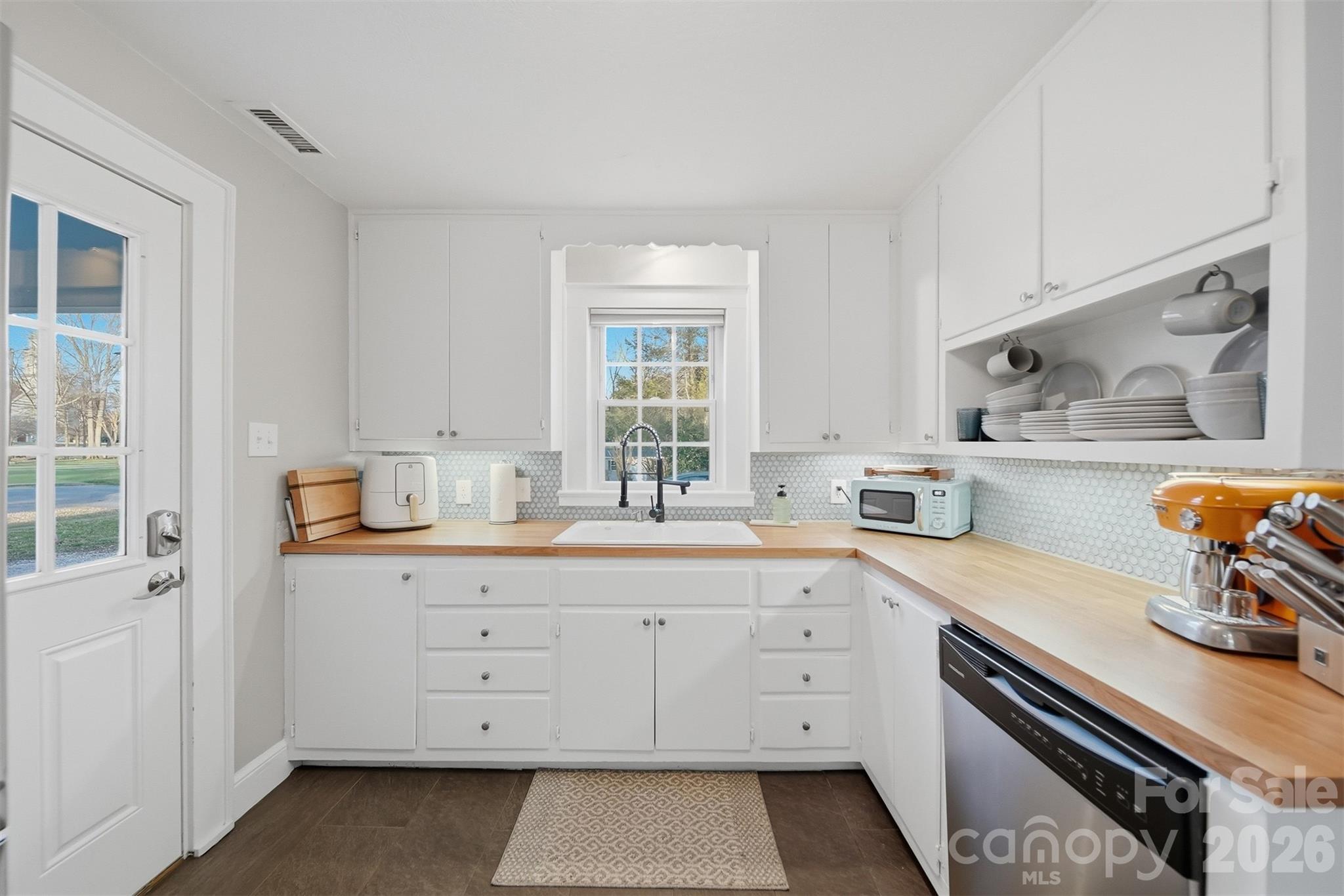 1519 3rd Street Northwest Hickory, NC 28601 - Photo 25 of 48 a kitchen with granite countertop white cabinets white stainless steel appliances and sink