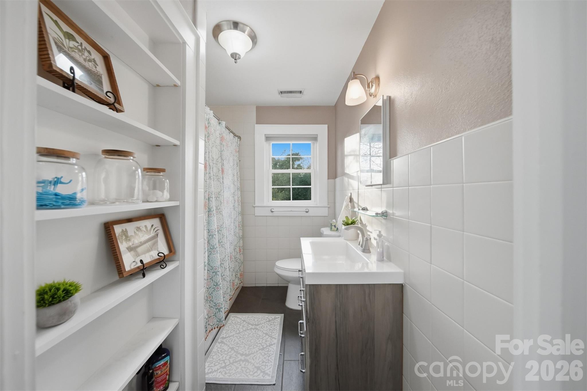 1519 3rd Street Northwest Hickory, NC 28601 - Photo 5 of 48 a bathroom with a sink a mirror and a window