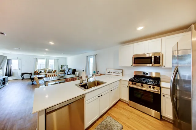 a kitchen with sink a stove and cabinets