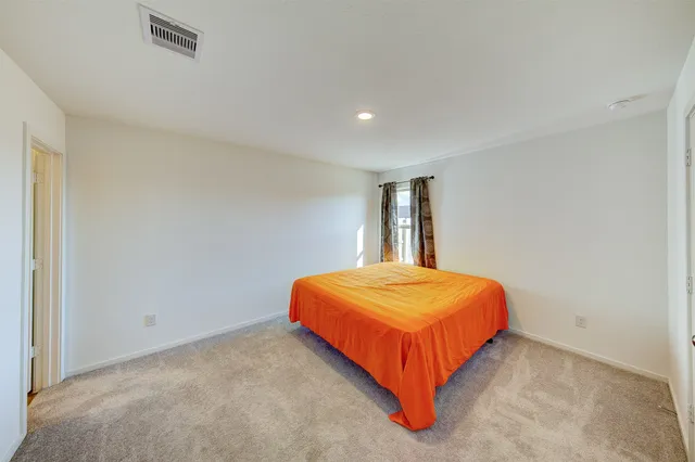 a bedroom with a bed and window