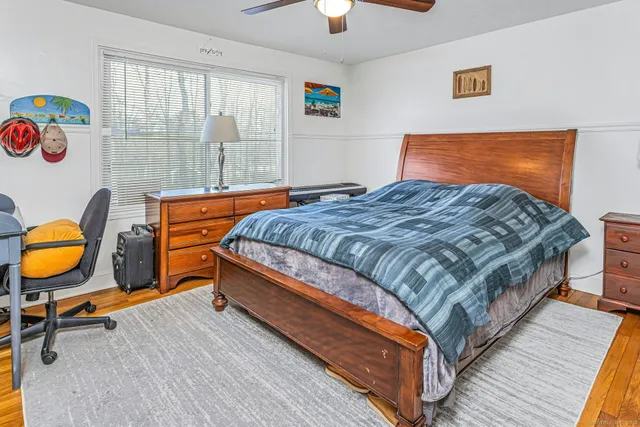 a bedroom with bed and window