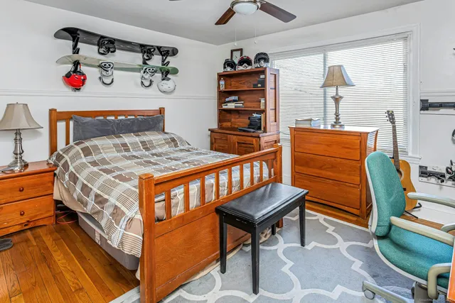a bedroom with a bed and wooden floor