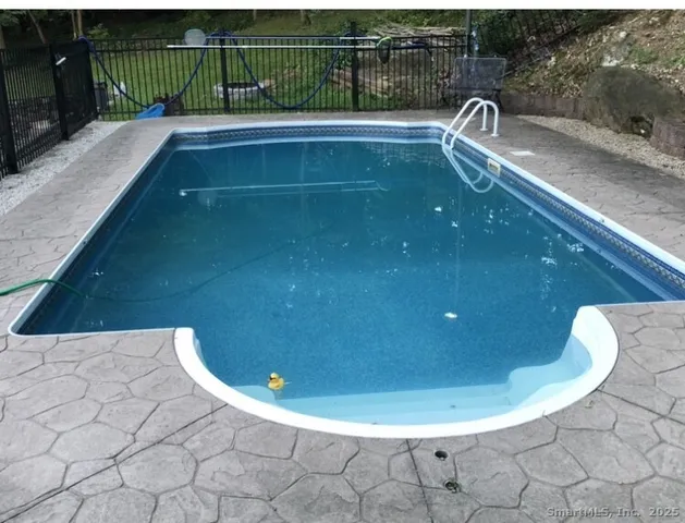 a view of a dry yard with large trees