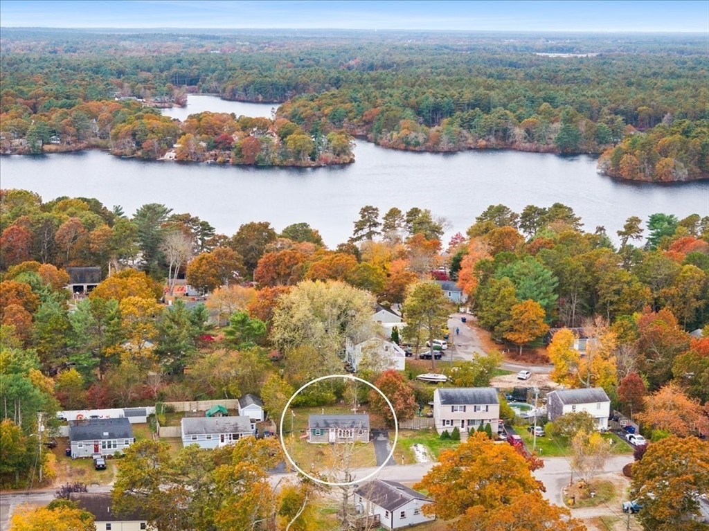 an aerial view of lake and residential houses with outdoor space