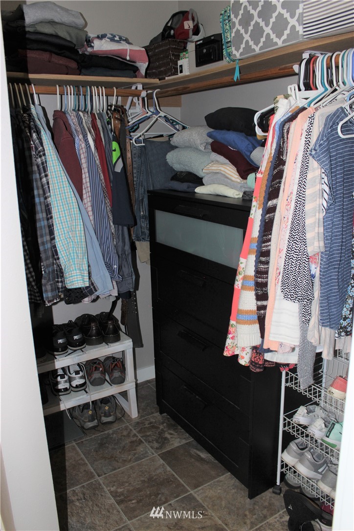 9239 Applegate Loop Southwest Rochester, WA 98579 - Photo 23 of 40 a view of walk in closet with clothes and shoes
