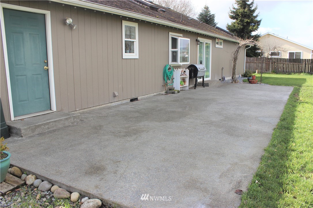 9239 Applegate Loop Southwest Rochester, WA 98579 - Photo 3 of 40 a view of a house with backyard and porch