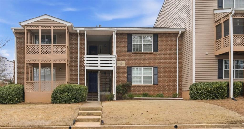 256 Quail Run, Unit 256 Roswell, GA 30076 - Photo 1 of 33 a front view of a house with a yard
