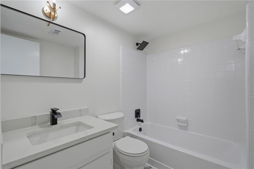 256 Quail Run, Unit 256 Roswell, GA 30076 - Photo 16 of 33 a bathroom with a sink a toilet and shower