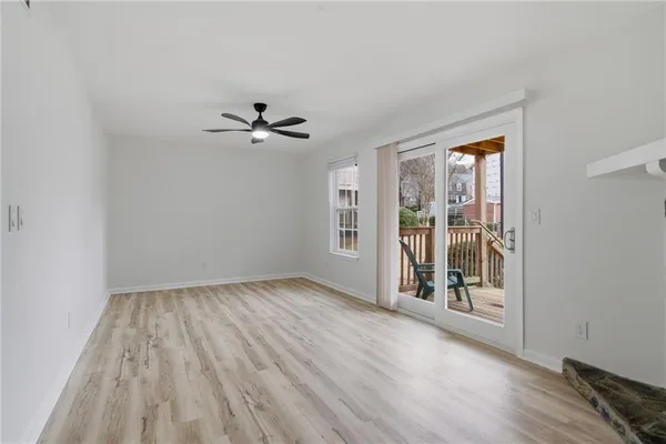 wooden floor in an empty room with a window