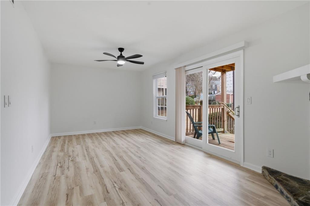 256 Quail Run, Unit 256 Roswell, GA 30076 - Photo 18 of 33 wooden floor in an empty room with a window
