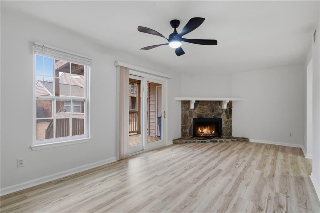 256 Quail Run, Unit 256 Roswell, GA 30076 - Photo 19 of 33 a view of an empty room with wooden floor fireplace and a window