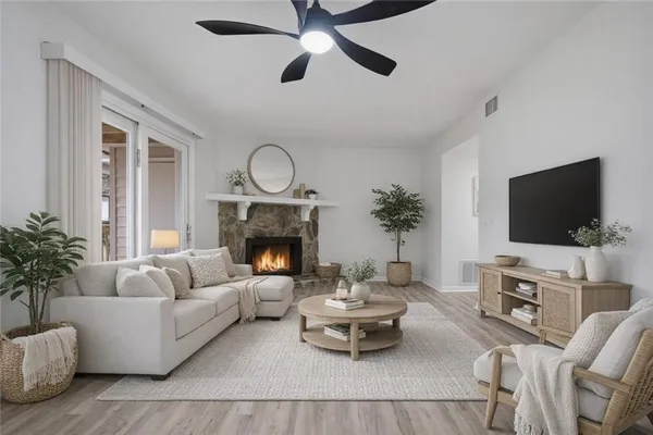a living room with furniture a fireplace and a flat screen tv