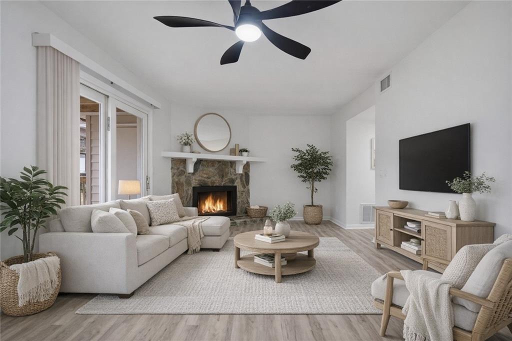 256 Quail Run, Unit 256 Roswell, GA 30076 - Photo 20 of 33 a living room with furniture a fireplace and a flat screen tv