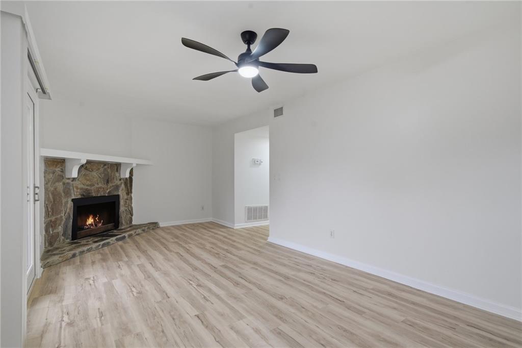 256 Quail Run, Unit 256 Roswell, GA 30076 - Photo 22 of 33 a view of an empty room with wooden floor and a fireplace