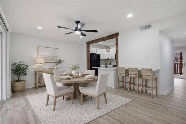 a view of a dining room with furniture and wooden floor