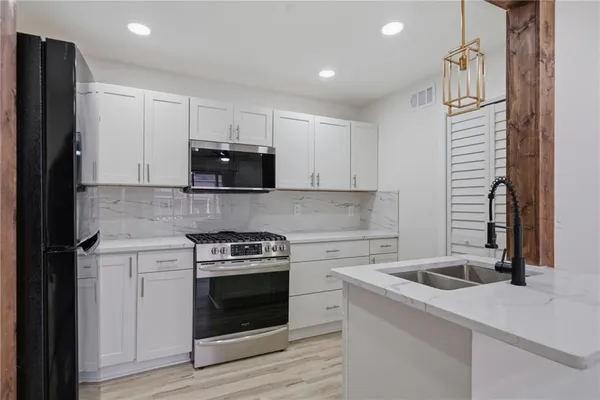 a kitchen with a stove and a microwave