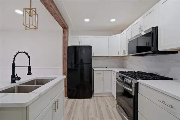 a kitchen with a sink cabinets and stainless steel appliances
