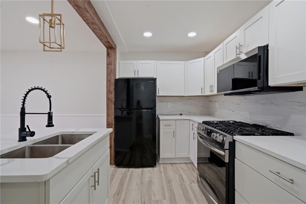 256 Quail Run, Unit 256 Roswell, GA 30076 - Photo 9 of 33 a kitchen with a sink cabinets and stainless steel appliances